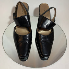 Asymmetrical strap button heels